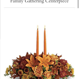 Autumn floral centerpiece with two orange taper candles