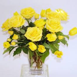 Yellow roses arranged in a clear glass vase