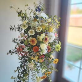 Loose bouquet of mixed wildflowers in white, yellow, orange, pink, and blue