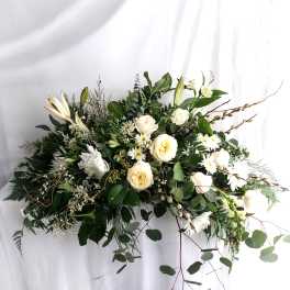 White floral spray with roses, lilies, and daisies in a cascading arrangement