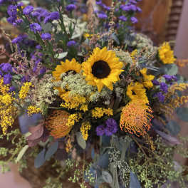 Bouquet with sunflowers, purple blooms, and yellow filler flowers