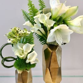 White calla lily arrangements in gold geometric vases