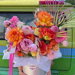 Large mixed bouquet in a silver hatbox with bright orange roses and pink blooms