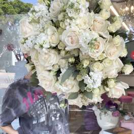Large bouquet of white roses and white flowers with greenery