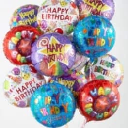 Cluster of colorful birthday balloons with printed messages