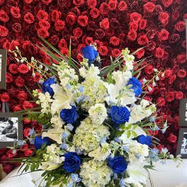Large blue, white, and cream floral spray on an easel
