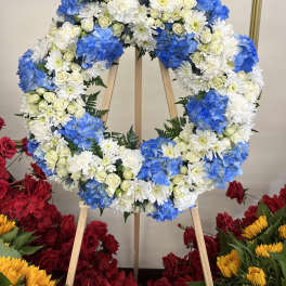 Blue and white floral wreath on a wooden easel