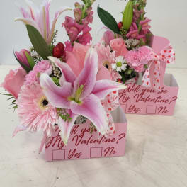 Pink floral gift boxes with lilies, roses, and a Valentine message
