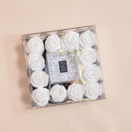 Square box of white roses with a clear jeweled center
