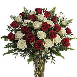 Red and white roses in a clear glass vase