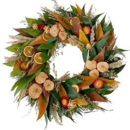 Autumn wreath with dried flowers, leaves, and orange slices