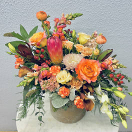 Colorful mixed flower arrangement in a round vase