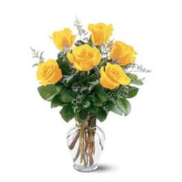 Yellow roses arranged in a clear glass vase