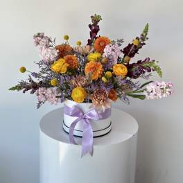 Mixed bouquet in a white hat box with a lavender ribbon