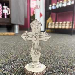 Decorative wooden cross on a small base