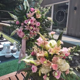 Large pink and white floral arrangement with lilies and roses