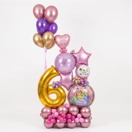 Pink, purple, and gold balloon arrangement with birthday balloons and a large number 6