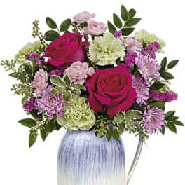 Pink and lavender mixed bouquet in a blue-and-white vase