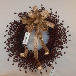 Decorative berry wreath with a gold glitter bow