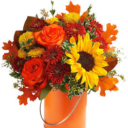 Orange and red bouquet with sunflowers and roses in an orange bucket