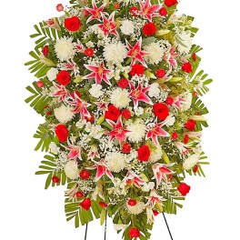Standing floral spray with red roses, white blooms, and pink lilies