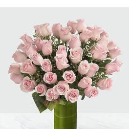 Pink roses arranged in a tall green vase