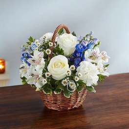 Basket of white and blue flowers on a table