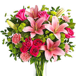 Pink lilies and roses in a clear glass vase