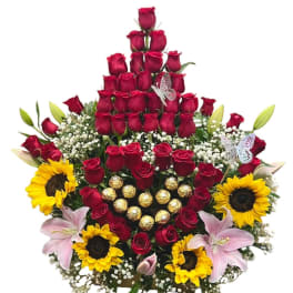 Tiered bouquet of red roses with sunflowers, lilies, and chocolates