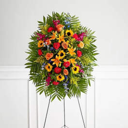 Standing floral spray with mixed bright flowers on an easel