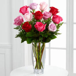 Bouquet of pink and red roses in a clear glass vase