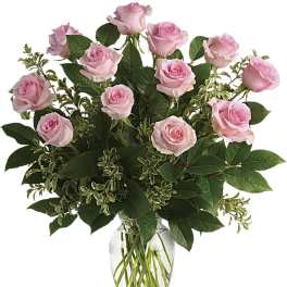 Pink roses arranged in a clear glass vase