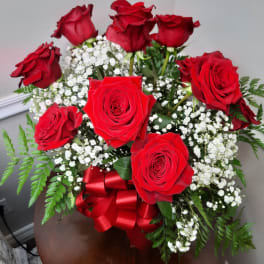 Bouquet of red roses with white baby's breath and a red ribbon