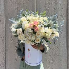 Large bouquet of cream and blush roses in a white hatbox