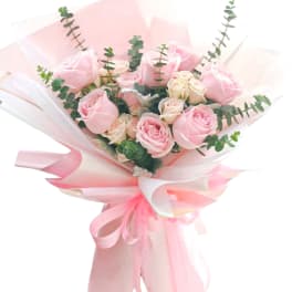 Pink and cream rose bouquet wrapped in pale pink paper