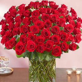 Large bouquet of red roses in a clear glass vase