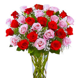 Bouquet of red and pink roses in a clear glass vase
