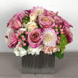 Pink and white rose bouquet in a square vase