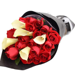 Bouquet of red roses and white calla lilies wrapped in black paper