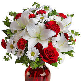 Red roses and white lilies in a red glass vase