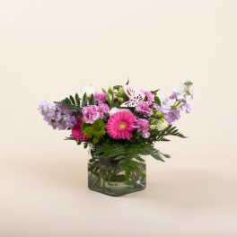 Pink and lavender mixed bouquet in a square glass vase