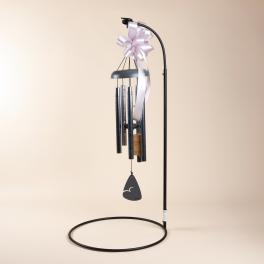 Black wind chime with a pale ribbon bow and hanging tag