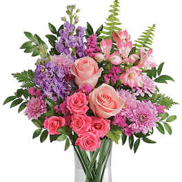 Pink and purple mixed bouquet in a clear glass vase