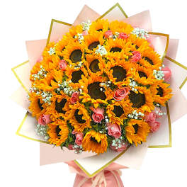 Bouquet of sunflowers and pink roses wrapped in pale pink paper