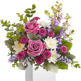 Pink roses and white daisies in a white box vase