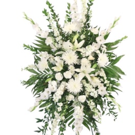White funeral spray with lilies and chrysanthemums on a standing easel