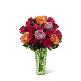 Bouquet of multicolored roses in a green glass vase