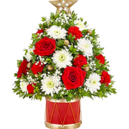 Red roses and white daisies arranged in a drum-shaped vase with a star topper