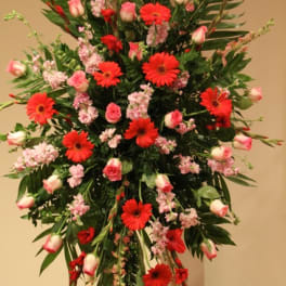 Tall floral spray with red gerbera daisies and pink roses