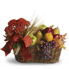 Fruit basket with red flowers and a large ribbon